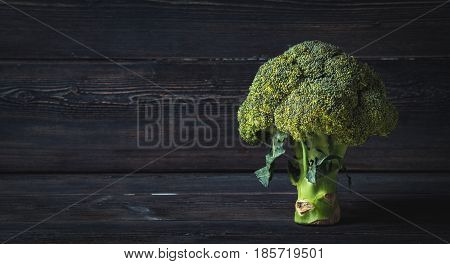 healthy bunch of broccoli on dark boards