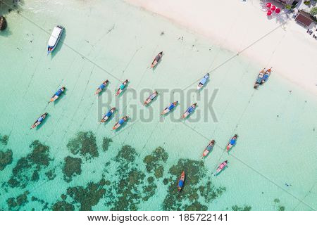 Aerial view over group of long tail boatsTop view from drone Koh Lipe island SatunThailand.