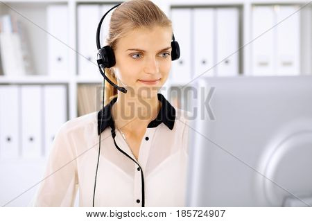 Modern business woman in headset the office.