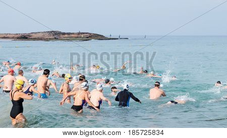 Nahariyya Israel - May 06 2017 : Participants of the annual triathlon start in the swim in the Mediterranean Sea in Ahziv near the town of Nahariya
