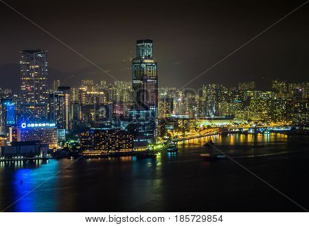 Harbor atmosphere and Hong Kong business district at night time.