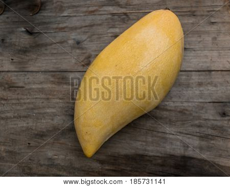 Yellow Mangoes On A Wooden Background. Copy Space For Text