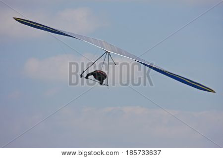 Hang glider flying in a blue sky