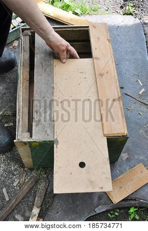 Beekeeper building wooden trap for wild bees or for swarming bees. Honey Bees Trap for Capture a Swarm and Install it in a Beehive.