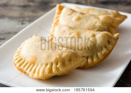 Delicious typical Spanish empanadas on wooden table