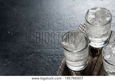 Vodka On The Rocks On An Old Wooden Table As Detailed Close-up Shot