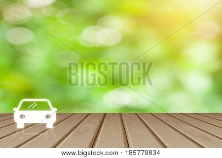 Business service car concept Wooden board empty top table Car icon with blurred tree with bokeh background - can be used for display or montage your products and text.