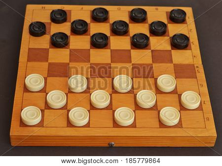 Sports or recreation Board game board with checkers. Hobby. Checkers on the playing field for the game.