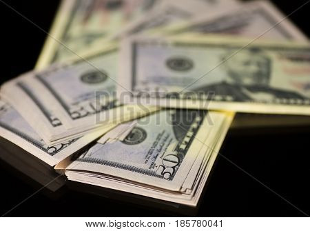 Paper money banknote bill 50 dollars usa on a black background