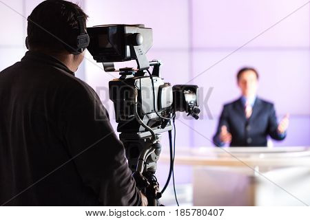 Closeup of a Camera Operator Filming an Anchorman