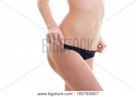 slender body of a young girl in black panties close-up isolated on white background