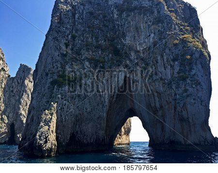 arched rock in the water found in capri, italy
abroad,adventure,air,amalfi,ancient,arches,architecture,art,beautiful,capri,colorful,colors,design,europe,fresh,italia,italian,italy,landmark,nature,ocean,outdoors,perspective,sorrento,summer,sun,sunny,sunshi