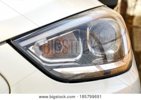 white Car headlights. Exterior detail automobile close-up