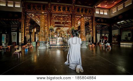 Ho Chi Minh City, Vietnam - November 27, 2015 - People praying in the buddhist temple Vinh Nghiem