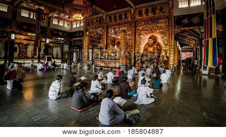 Ho Chi Minh City, Vietnam - November 27, 2015 - People praying in the buddhist temple Vinh Nghiem