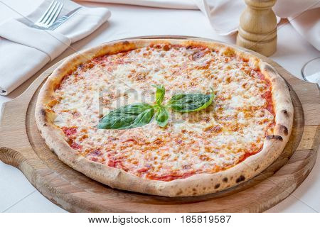 Pizza Margarita with cheese tomatoes sauce and Basil