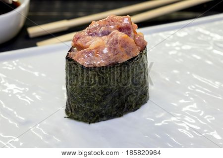 Gunkan with fresh tuna on a white plate