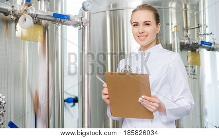 Female young attractive specialist at water factory