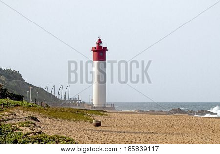 Green Vegetation Beach And Redllighthouse Seascape