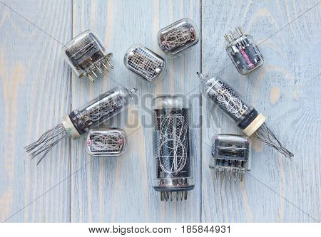 Different tipes of nixie tubes on wooden background.