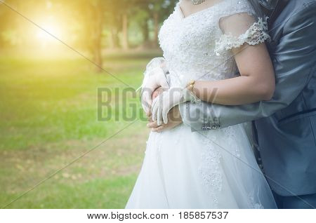 Weding in park with golden light in the morning