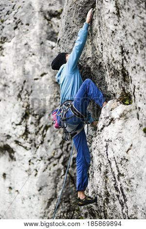 Podlesice Poland april 29 2017: Young male climber leading a route on a rock. Jura krakowska czestochowska. Poland