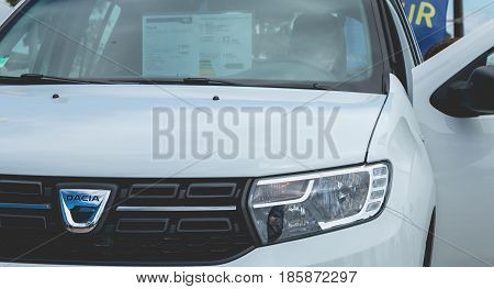 Sables d Olonne France - May 07 2017 : Dacia Tour 2017 is a commercial operation organized by the car builder in order to present its cars throughout France - A young man watching a car