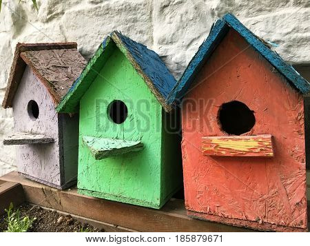 Three funny color birdhouses on the street