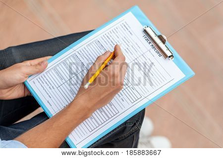 Closeup of a Person Filling a Track Record