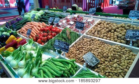 Greengrocery with shelf with fresh vegetables and fruits
