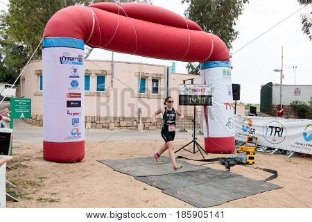 Nahariyya Israel - May 06 2017 : Participant of the annual triathlon finishes in the race in Ahziv near the town of Nahariya