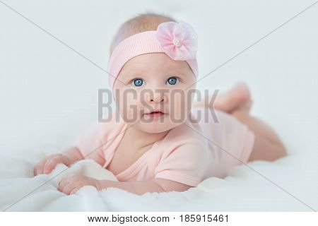 Portrait of adorable baby girl in pink dress.