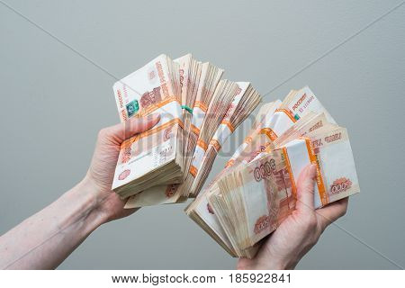 female hand holding of many Russian banknotes