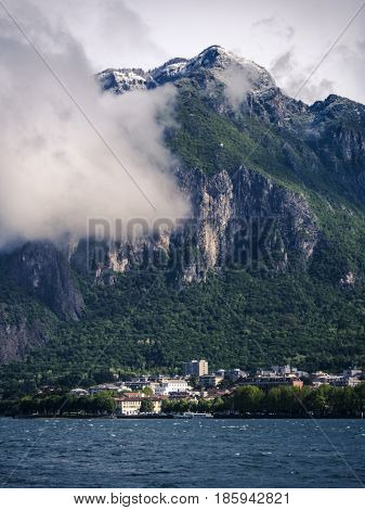 View to beautiful snowy and cloudy mountains during spring.