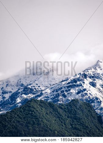 Snowy and cloudy beautiful mountains during spring.
