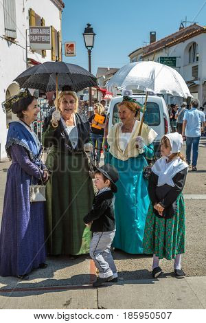 Saint-Marie-de-la-Mer, Provence, France - May 25, 2015. Women and children in fabulously beautiful medieval clothes. The gypsies feast of St. Sara. The concept of ethnographic tourism 