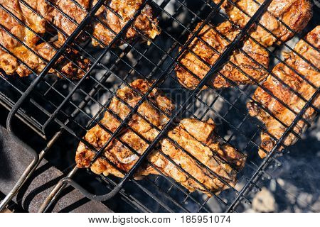 Pieces of fried lamb meat and pork on the grill. Delicious festive barbecue. Marinated beef BBQ Skewers. Food and holliday concept.