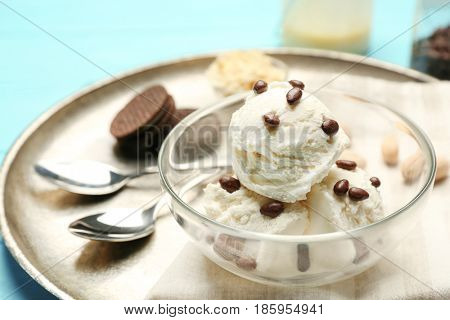 Glass bowl with delicious ice cream on tray