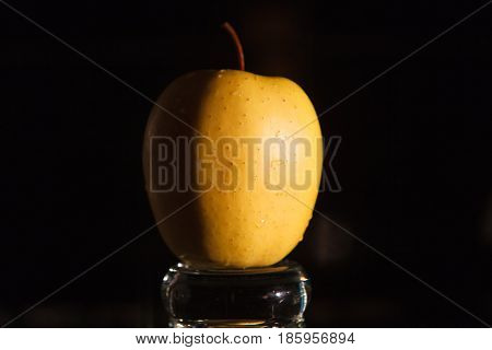 Yellow apples in a vase on a dark background. Beautiful apple.