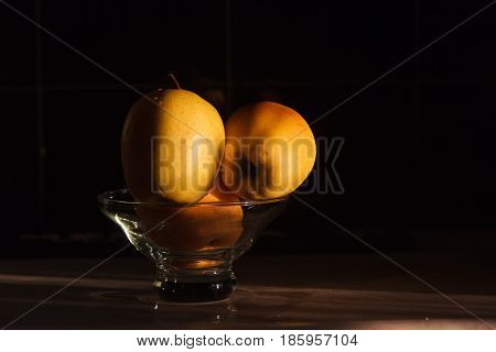 Yellow apples in a vase on a dark background. Beautiful apple.