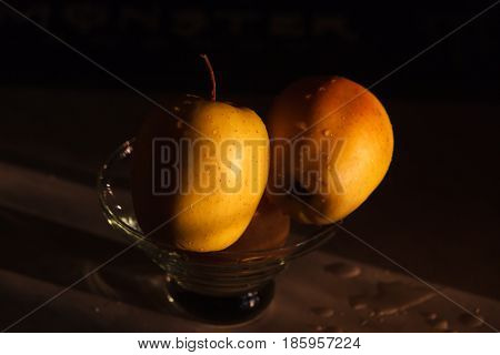 Yellow apples in a vase on a dark background. Beautiful apple.
