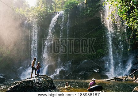 SIEM REAP, CAMBODIA - JANUARY 27, 2015: Local people swimming at waterfall in Phnom Kulen waterfall.