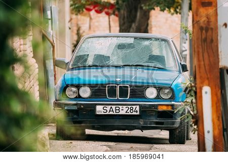 Tbilisi, Georgia - October 21, 2016: Old rusty sedan car BMW 3 Series E30 parking on street. The BMW E30 is an entry-level luxury car which was produced by BMW from 1982 to 1994.