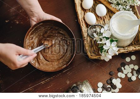 woman hands makeing cake on wooden background