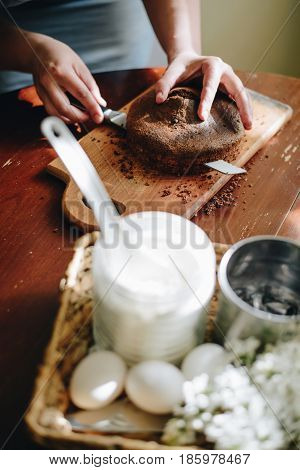 woman hands makeing cake on wooden background