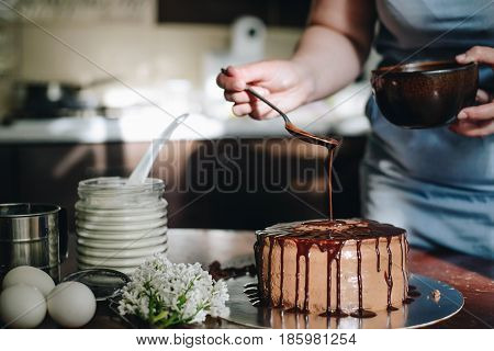woman hands makeing cake on wooden background