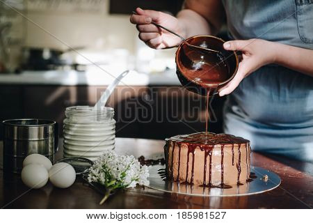 woman hands makeing cake on wooden background