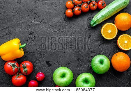 Organic fruits and vegetables for healthy dinner on darkbackground top view mock up