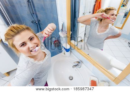 Woman Brushing Cleaning Teeth In Bathroom