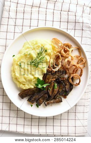 Mashed Potatoes With Fried Beef Liver With And Onion Rings On White Plate. Pieces Liver (offal) From